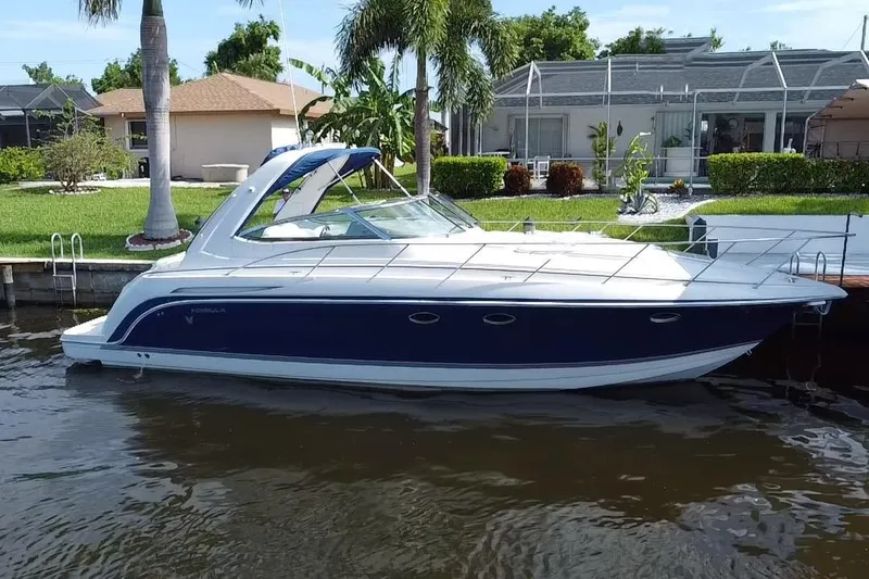 Slide: The Image of 2003 Formula 37PC boat docked by waterfront homes. - 21