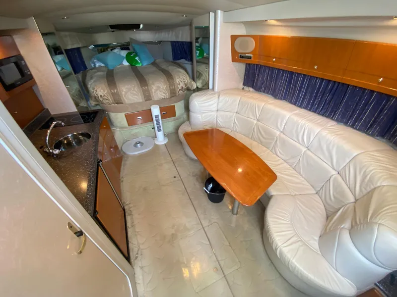 Slide: The Image of Interior of a 2003 Formula 37PC yacht with a cozy seating area and bed. - 22
