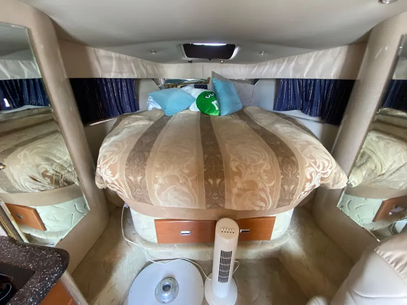 Slide: The Image of Interior cabin of a 2003 Formula 37PC boat with a cozy bed and fan. - 24