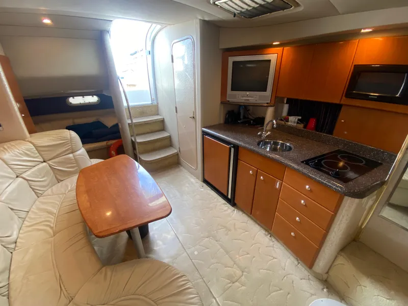 Slide: The Image of 2003 Formula 37PC yacht interior with kitchen, dining area, and stairs. - 25