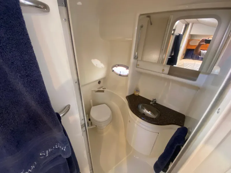 Slide: The Image of Compact bathroom in 2003 Formula 37PC yacht with sink, toilet, and mirror. - 27