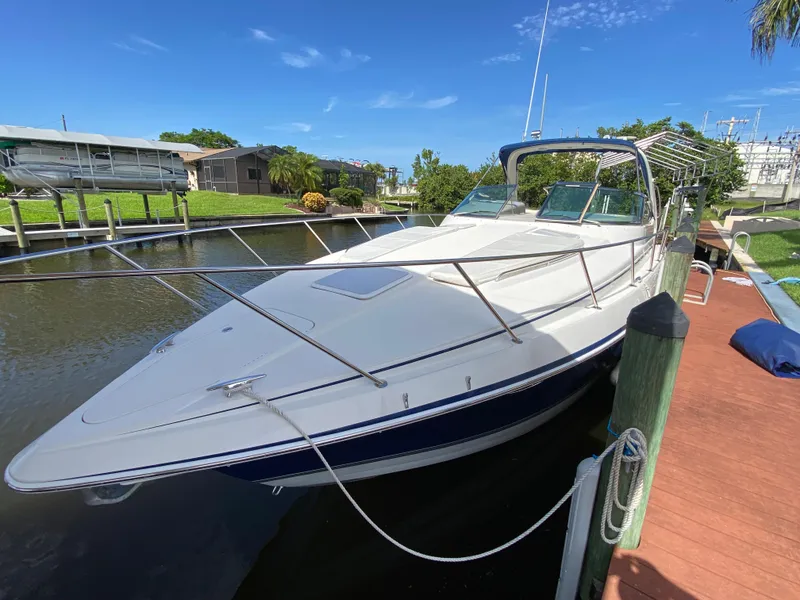 Slide: The Image of 2003 Formula 37PC boat docked in a serene marina. - 7