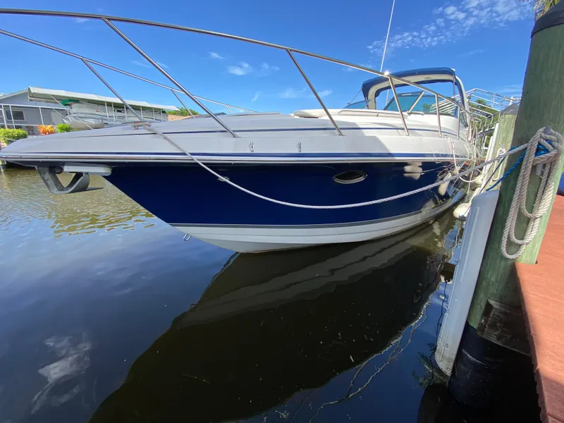 Slide: The Image of 2003 Formula 37PC boat docked in a marina on a sunny day. - 8