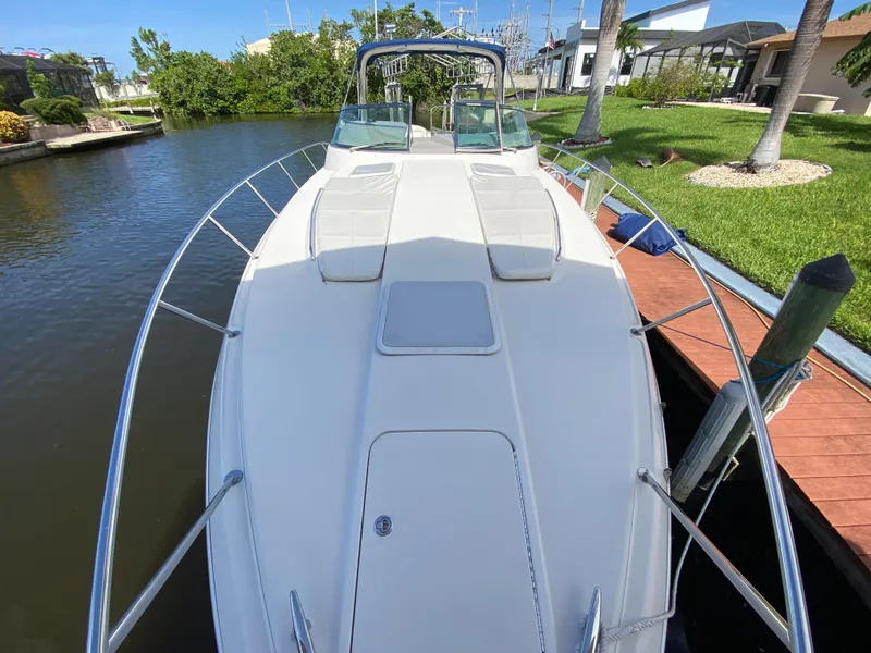 Slide: The Image of 2003 Formula 37PC boat docked by a canal, front deck view. - 9