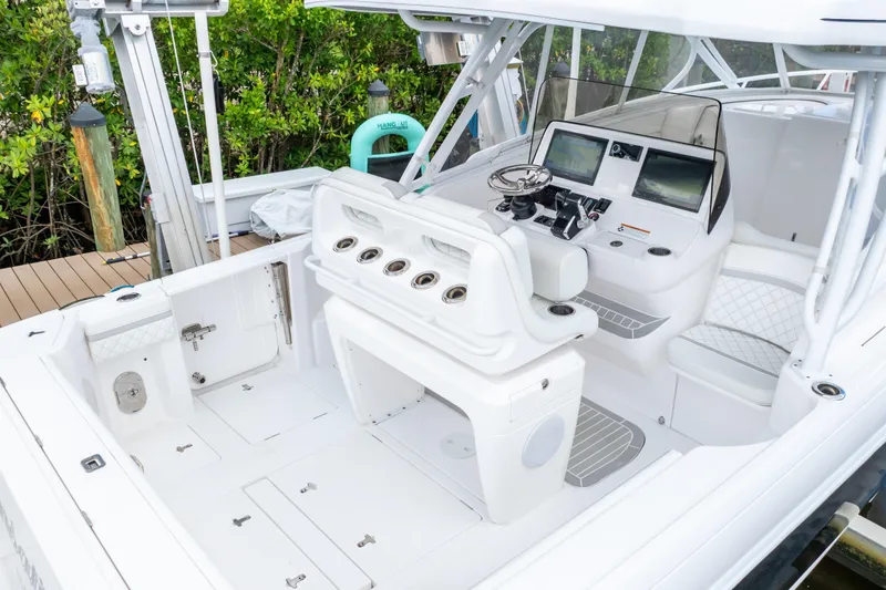 Slide: The Image of 2023 Intrepid 345 Valor boat interior with helm, seating, and fishing rod holders. - 1