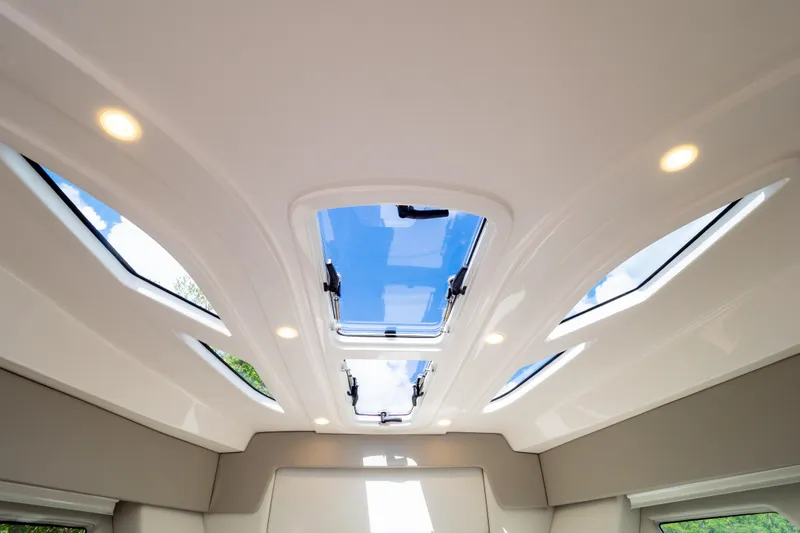 Slide: The Image of 2023 Intrepid 345 Valor cabin ceiling with skylights and recessed lighting. - 103