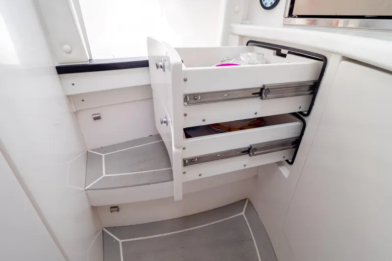 Slide: The Image of 2023 Intrepid 345 Valor boat interior with open storage drawers. - 111