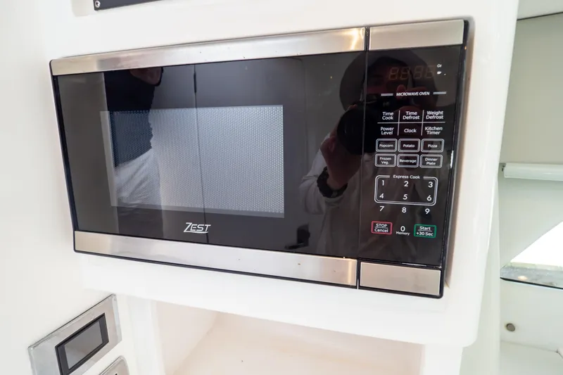 Slide: The Image of Microwave oven in 2023 Intrepid 345 Valor boat kitchen area. - 117