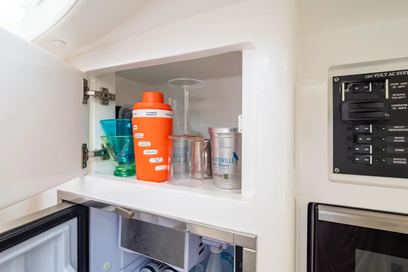 Slide: The Image of 2023 Intrepid 345 Valor interior cabinet with glasses and drinkware. - 118