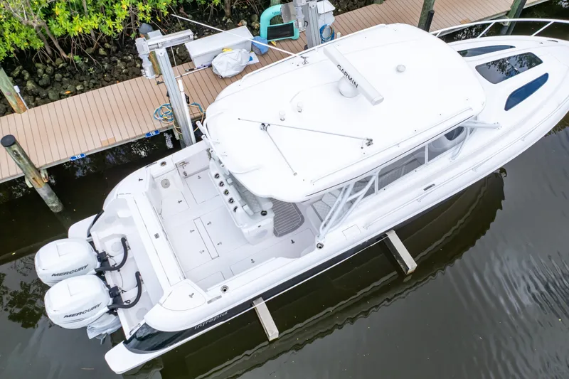 Slide: The Image of 2023 Intrepid 345 Valor boat docked, aerial view, featuring twin Mercury engines. - 120