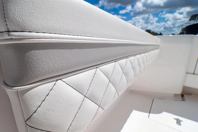 Slide: The Image of Luxurious white leather seating on 2023 Intrepid 345 Valor boat under blue sky. - 121