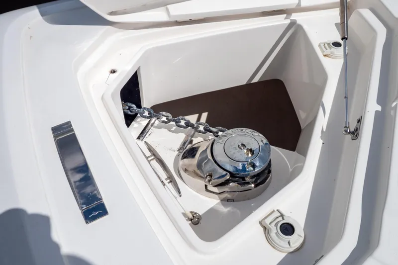 Slide: The Image of Anchor compartment of 2023 Intrepid 345 Valor boat with chain and winch. - 130
