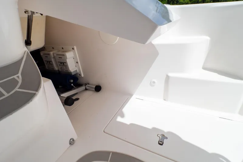Slide: The Image of 2023 Intrepid 345 Valor boat interior, showcasing storage compartment and hydraulic components. - 132