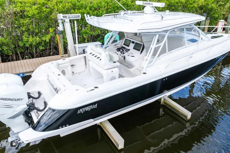 Slide: The Image of 2023 Intrepid 345 Valor boat docked, featuring sleek design and advanced navigation equipment. - 14