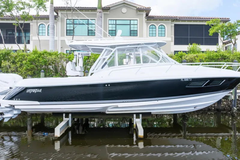 Slide: The Image of 2023 Intrepid 345 Valor boat docked near waterfront property. - 15