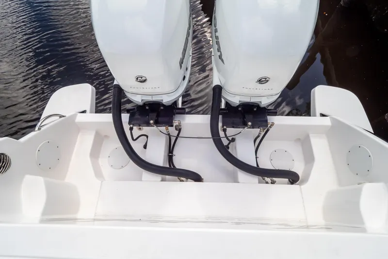 Slide: The Image of 2023 Intrepid 345 Valor boat with dual outboard engines on water. - 26