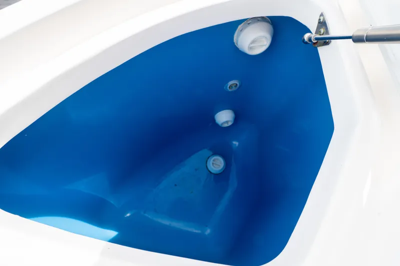 Slide: The Image of 2023 Intrepid 345 Valor boat storage compartment with blue interior and hydraulic support. - 32