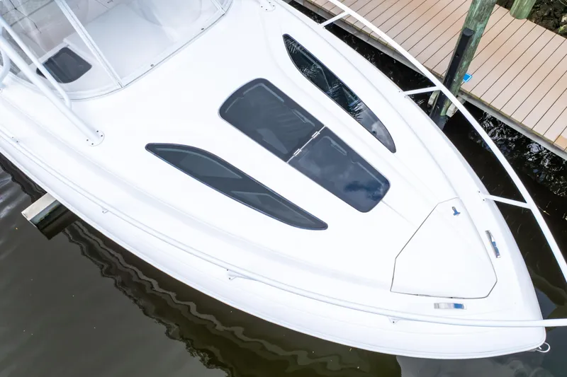 Slide: The Image of 2023 Intrepid 345 Valor boat docked, showcasing sleek white deck design and modern features. - 4