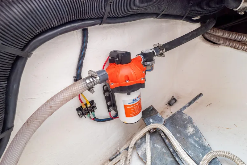 Slide: The Image of 2023 Intrepid 345 Valor water pressure pump system with hoses and wiring. - 44