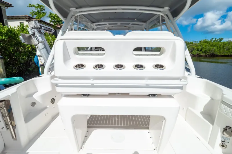 Slide: The Image of 2023 Intrepid 345 Valor boat interior with rod holders, sleek design, and spacious seating. - 48