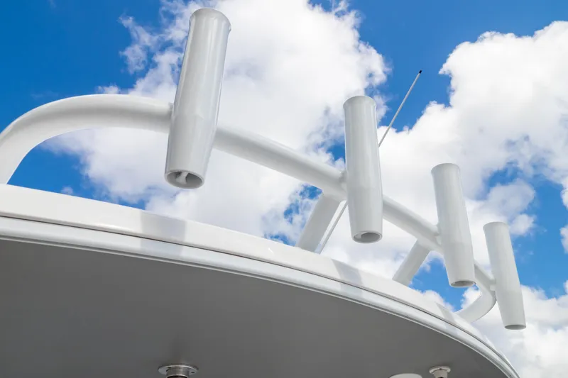 Slide: The Image of 2023 Intrepid 345 Valor boat with rod holders against a blue sky. - 51