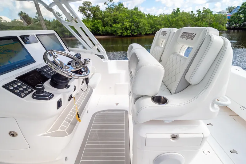 Slide: The Image of 2023 Intrepid 345 Valor boat interior with modern helm and luxurious seating. - 54
