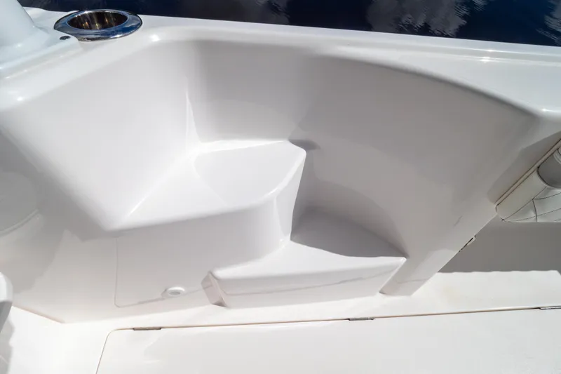 Slide: The Image of 2023 Intrepid 345 Valor boat interior detail with white seating and cup holder. - 64