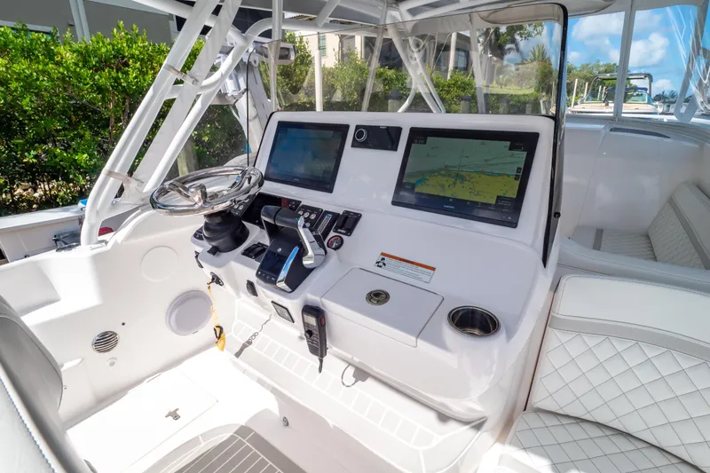 Slide: The Image of 2023 Intrepid 345 Valor boat cockpit with advanced navigation displays and luxurious seating. - 68