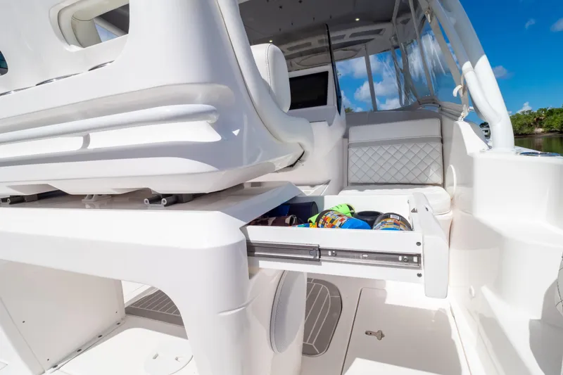 Slide: The Image of 2023 Intrepid 345 Valor boat interior with open storage drawer, showcasing modern design. - 69