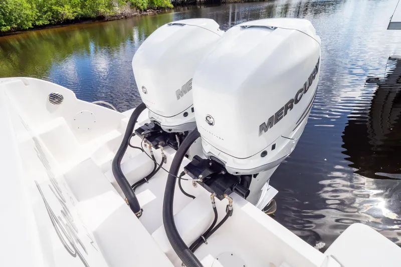 Slide: The Image of 2023 Intrepid 345 Valor with dual Mercury outboard engines on calm water. - 7