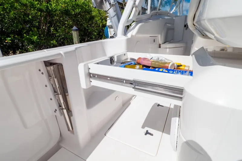 Slide: The Image of 2023 Intrepid 345 Valor boat with open storage drawer, showcasing onboard amenities. - 70
