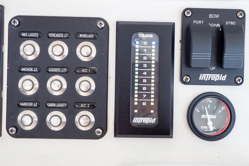Slide: The Image of Control panel of 2023 Intrepid 345 Valor boat with switches and gauges. - 74