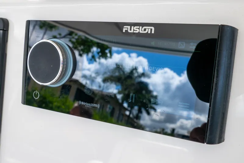 Slide: The Image of Fusion audio system on 2023 Intrepid 345 Valor boat, featuring Bluetooth and SiriusXM capabilities. - 75