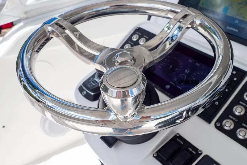 Slide: The Image of Steering wheel of 2023 Intrepid 345 Valor boat with modern dashboard controls. - 77