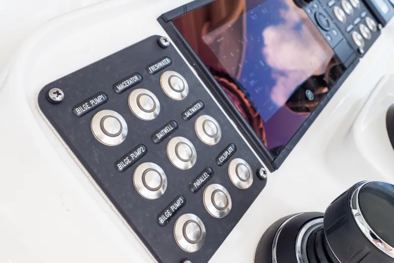Slide: The Image of Control panel of 2023 Intrepid 345 Valor boat with labeled buttons and display screen. - 79