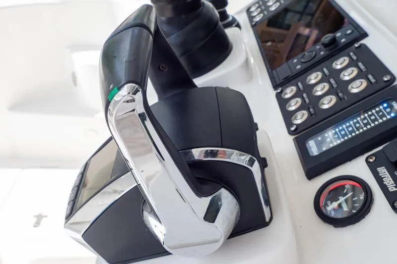 Slide: The Image of Close-up of 2023 Intrepid 345 Valor boat controls and dashboard. - 81