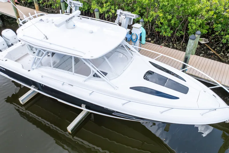 Slide: The Image of 2023 Intrepid 345 Valor boat docked, featuring sleek design and modern amenities. - 87