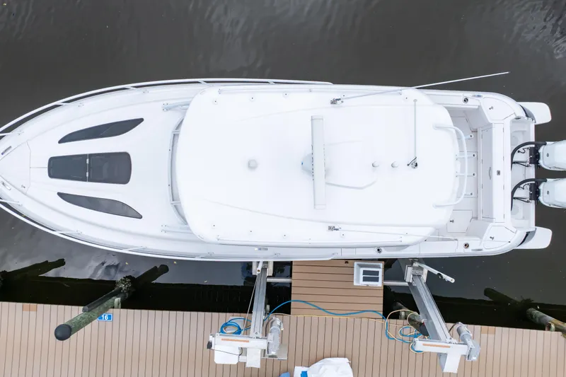 Slide: The Image of Aerial view of 2023 Intrepid 345 Valor boat docked, showcasing sleek design and twin engines. - 9