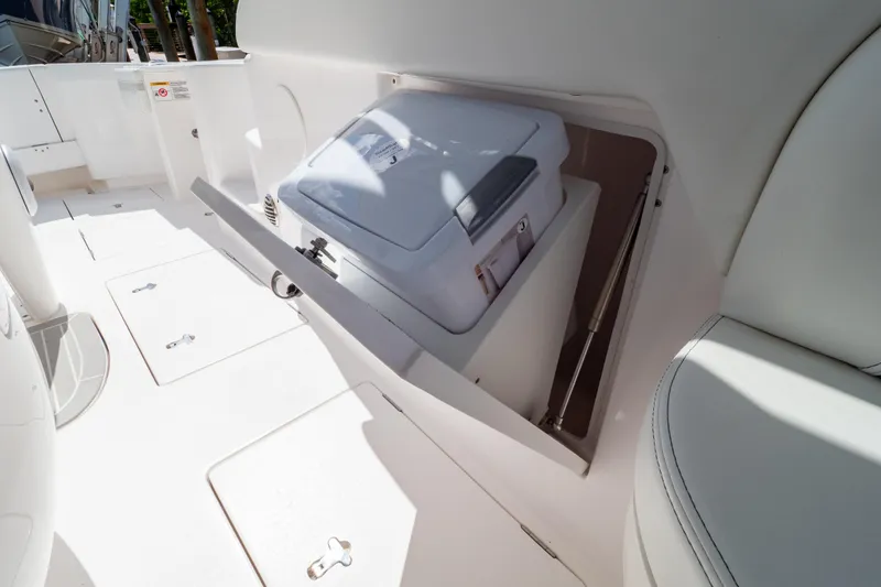 Slide: The Image of 2023 Intrepid 345 Valor boat interior with storage compartment and seating. - 93