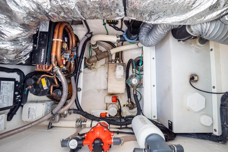 Slide: The Image of Engine compartment of 2023 Intrepid 345 Valor boat, showcasing complex mechanical systems. - 95