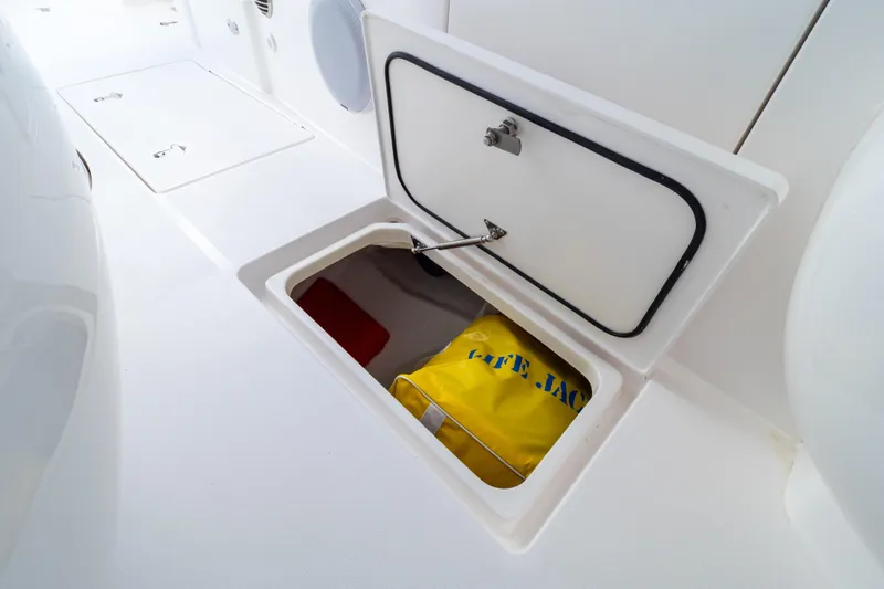 Slide: The Image of Storage compartment on 2023 Intrepid 345 Valor boat with life jacket inside. - 99