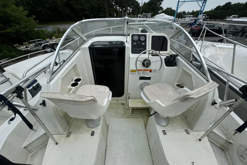 Slide: The Image of 2000 Hydra-Sports 212 Seahorse WA boat cockpit with dual seats and steering wheel. - 4