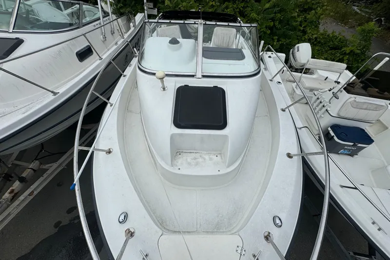 Slide: The Image of 2000 Hydra-Sports 212 Seahorse WA boat, white exterior, docked among other boats. - 6