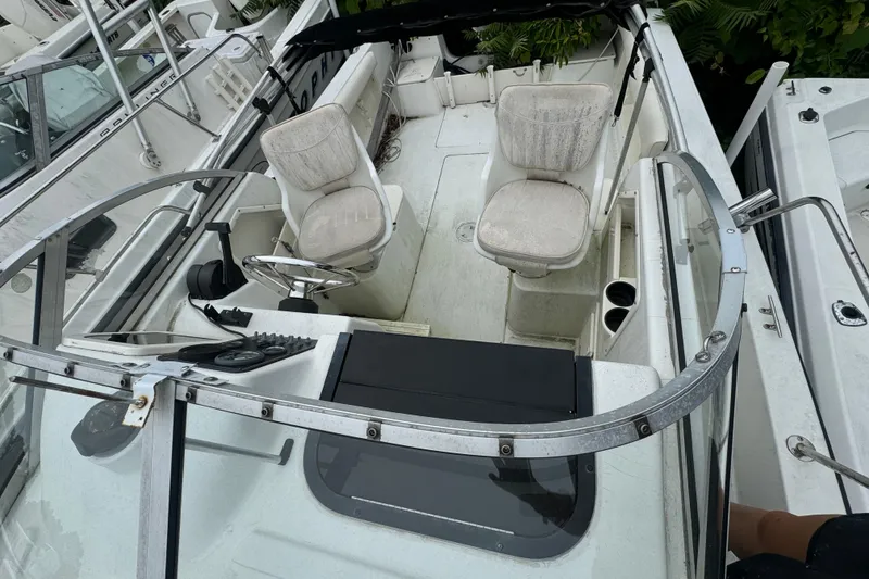 Slide: The Image of 2000 Hydra-Sports 212 Seahorse WA boat interior with seating and steering wheel. - 7