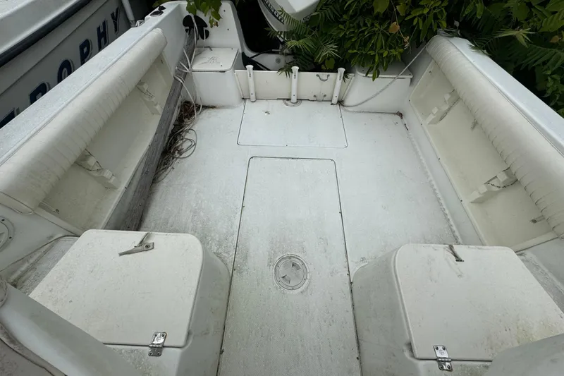Slide: The Image of 2000 Hydra-Sports 212 Seahorse WA boat interior with white seating and storage compartments. - 9