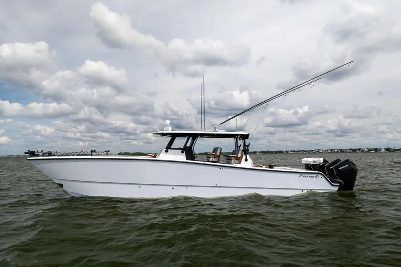 Slide: The Image of 2025 Freeman 42 LR boat on water under cloudy sky. - 1