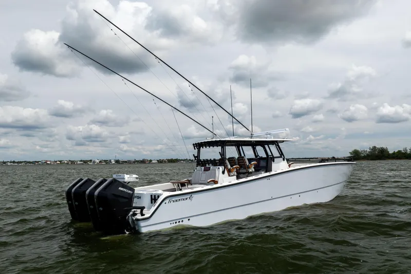 Slide: The Image of 2025 Freeman 42 LR boat on water with fishing rods and Mercury engines. - 12