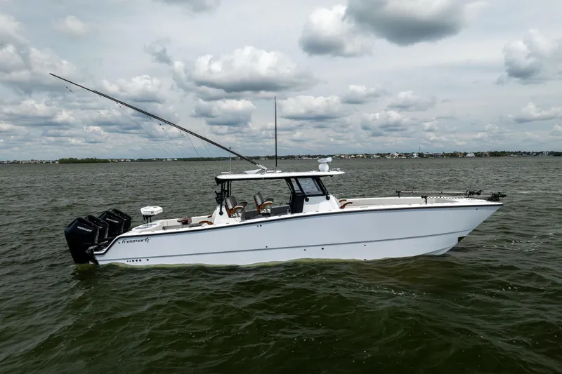 Slide: The Image of 2025 Freeman 42 LR boat on water, featuring sleek design and multiple outboard engines. - 14