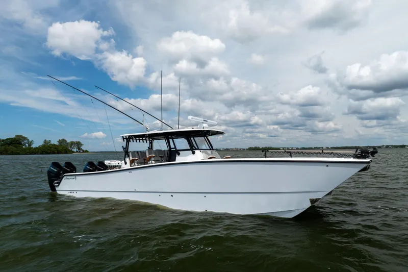 Slide: The Image of 2025 Freeman 42 LR boat on water under cloudy sky. - 15