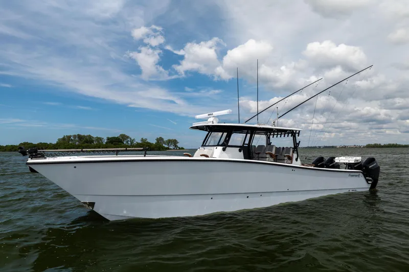 Slide: The Image of 2025 Freeman 42 LR boat on water under blue sky with clouds. - 18